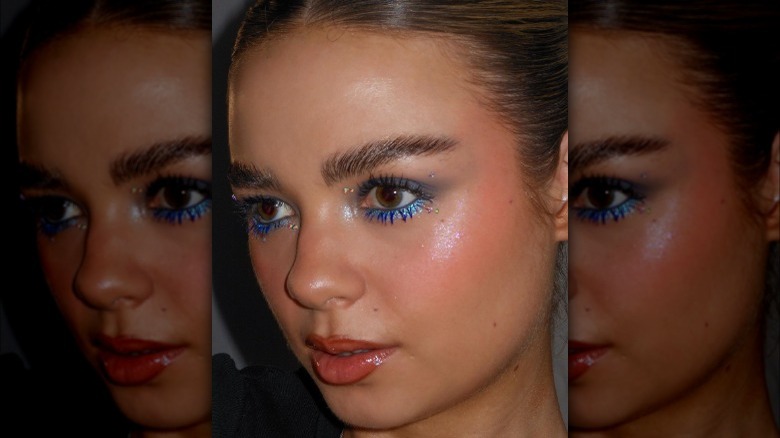 A woman with glittery blue underliner