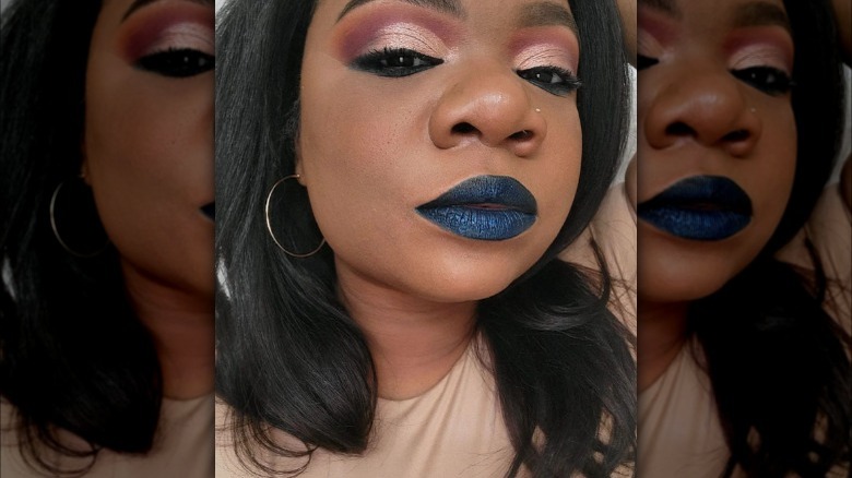 A woman with metallic blue lipstick