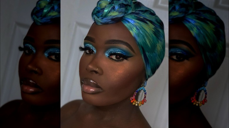 A woman with glittery blue cut-crease eyeshadow