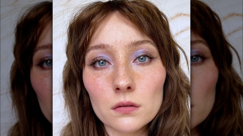 A woman with iridescent blue eyeshadow