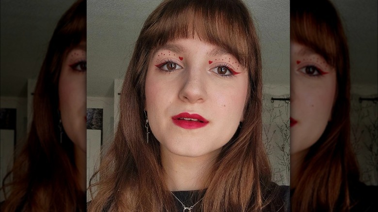 Woman with red eyeliner and hearts