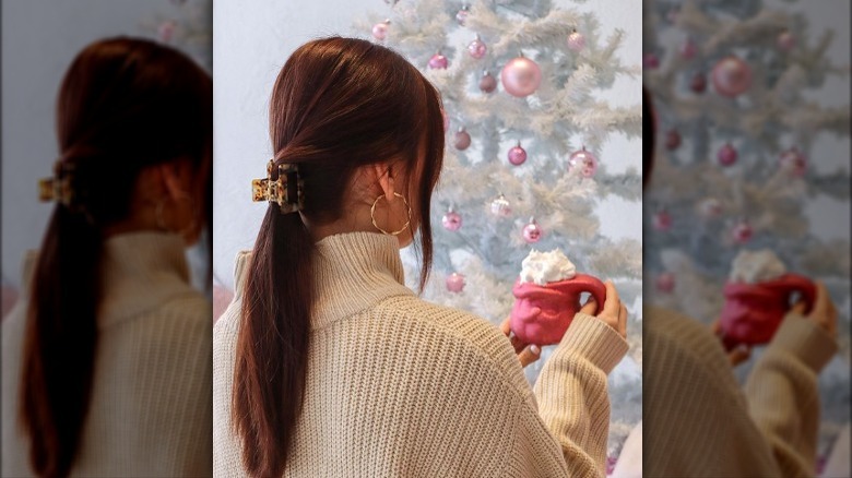 Woman holding pink coffee mug