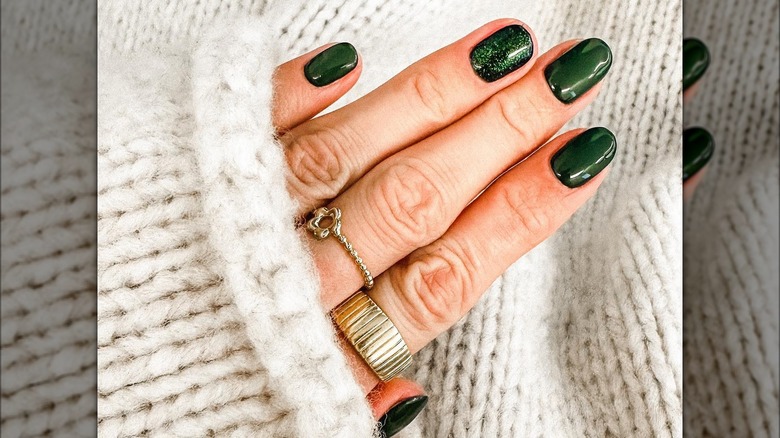 hand with green holiday nails
