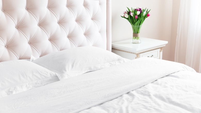 A bed made with white linens