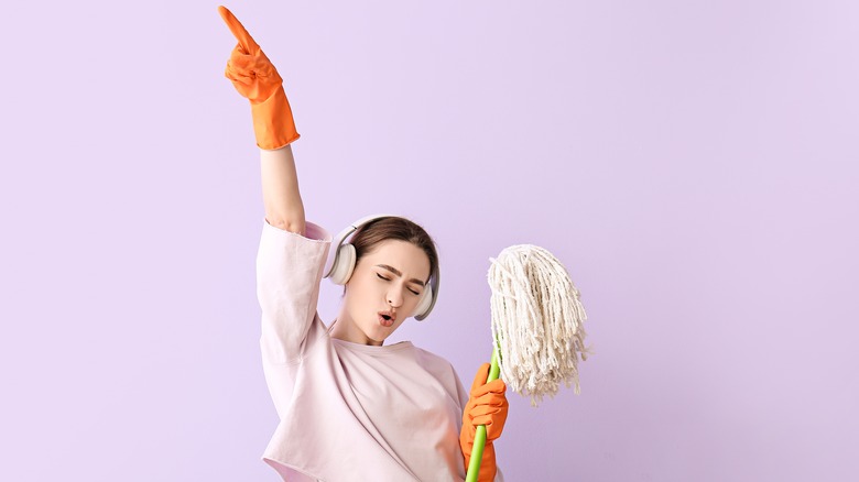 woman singing while mopping