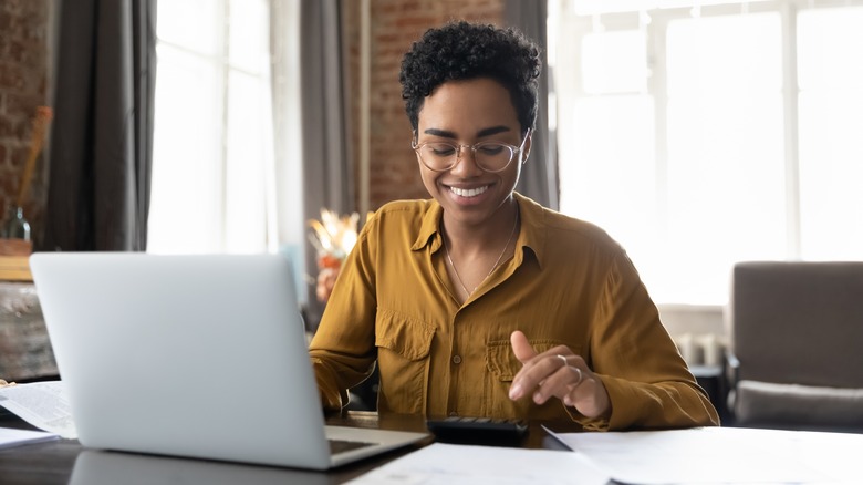 smiling Black woman on laptop