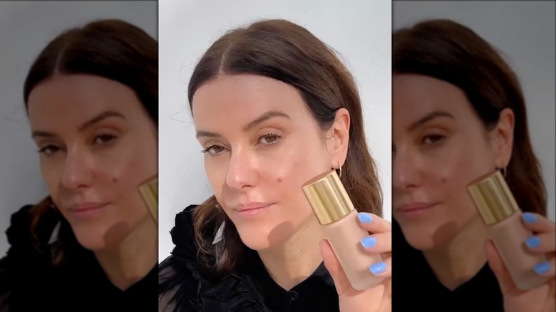 Lisa Eldridge holding makeup bottle