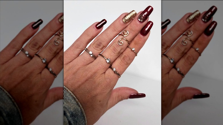 Burgundy nails with gold on fingers