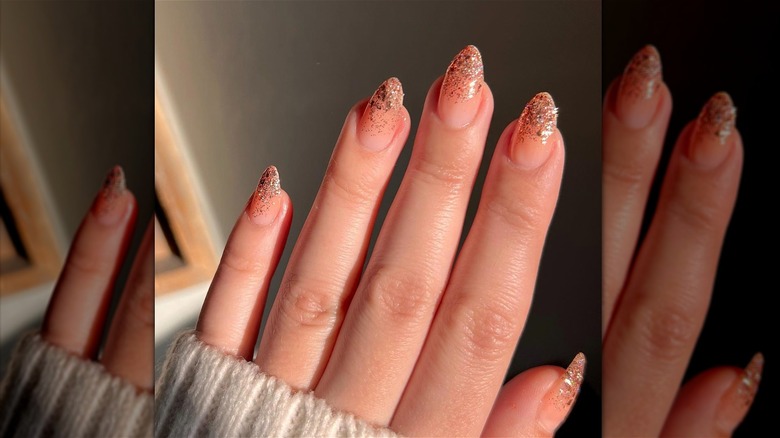 Golden sparkle tip nails on fingers