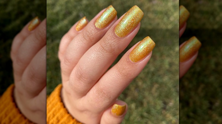 Shimmery golden nails on fingers