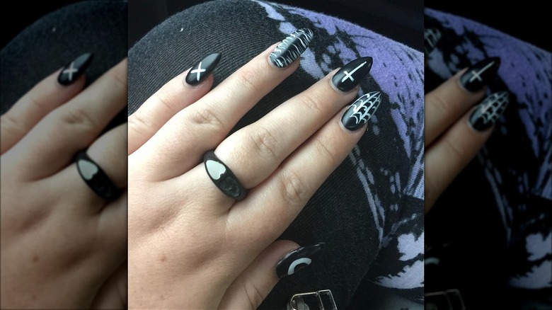 Black nails with witchy symbols 