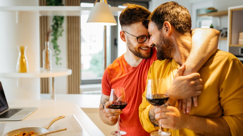 Close gay couple in kitchen