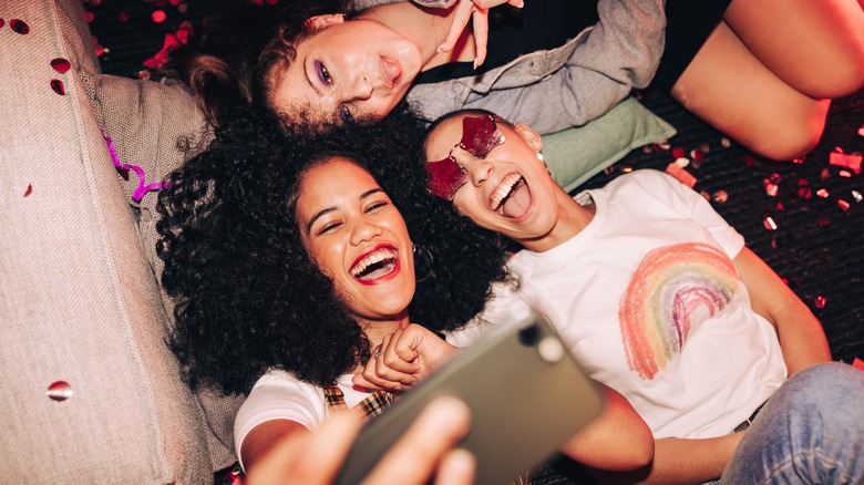 Happy women taking selfie at party