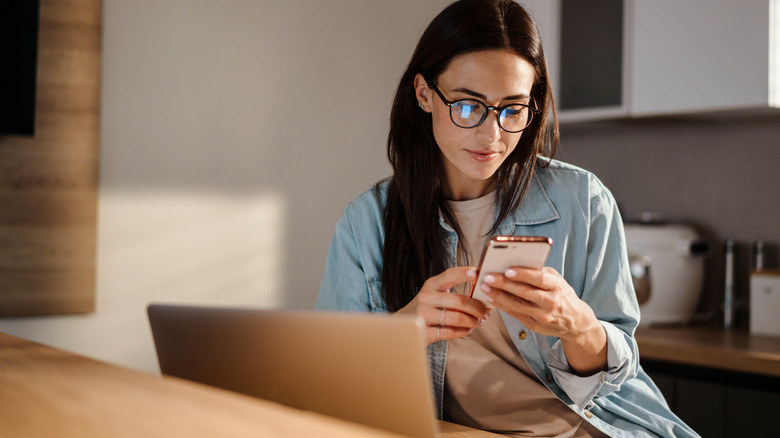 woman on her phone and computer