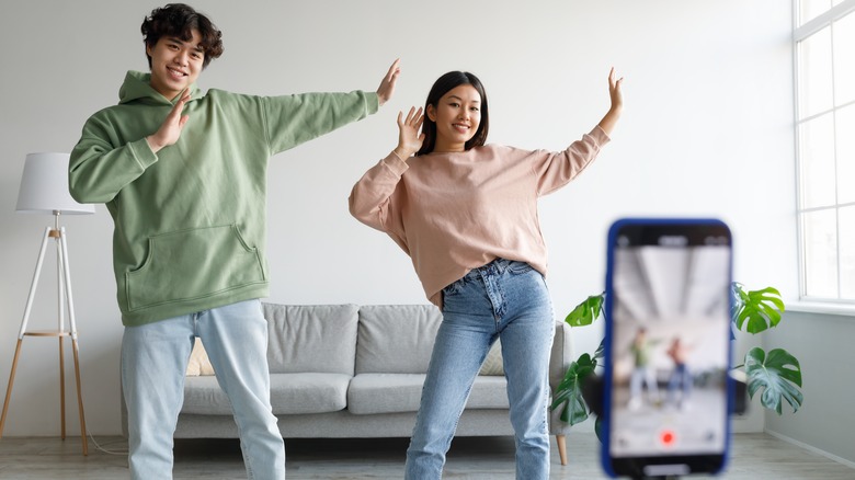 happy couple making TikTok video