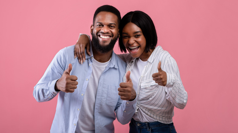 happy couple giving thumbs up