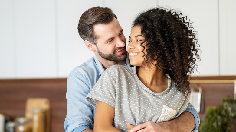 happy interracial couple hugging