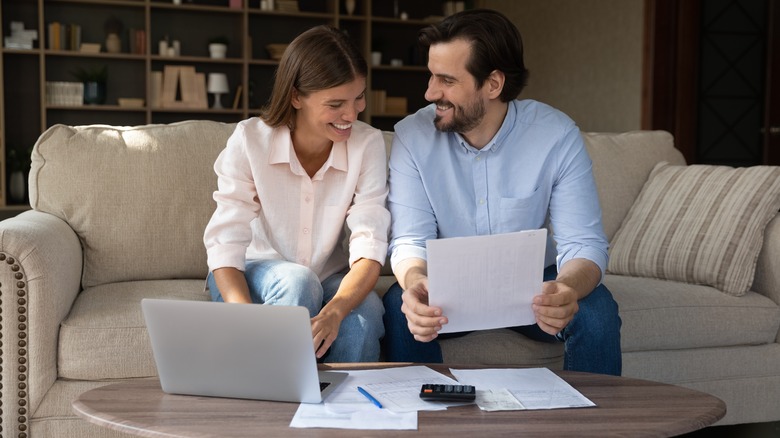 couple handling money documents