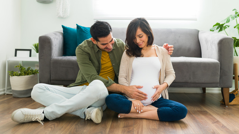 happy pregnant couple at home