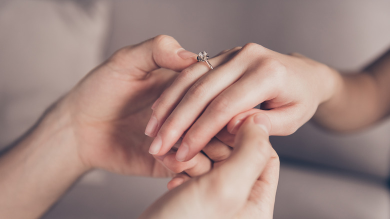 Putting wedding ring on finger