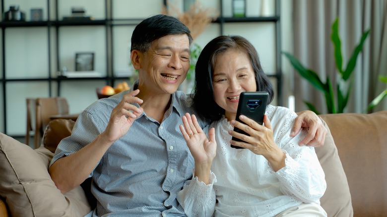 Couple calling family on phone