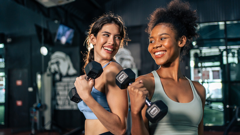 Two women smiling at gym