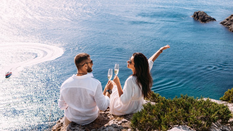 happy couple on an oceanside cliff