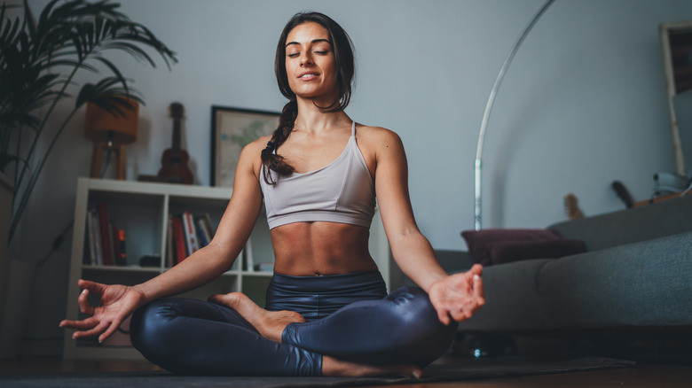 fit woman sits in meditation