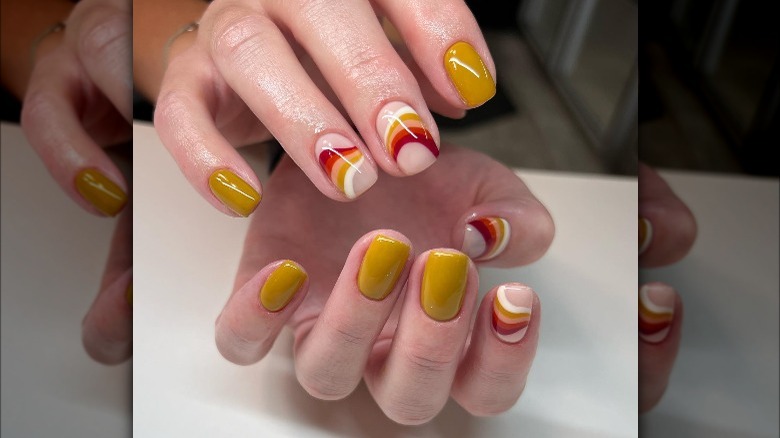 yellow and swirl manicure