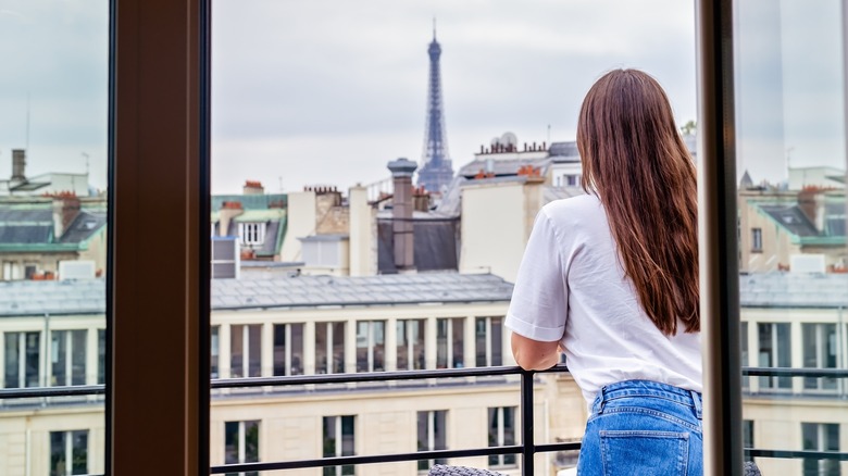 woman looking at Eiffel Tower from porch