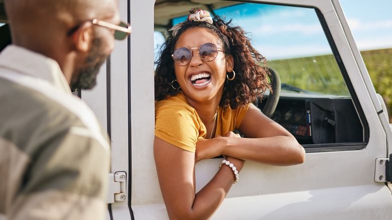 woman smiling out of car window