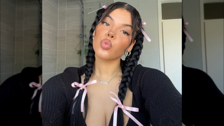 A woman with pink bows on her braids