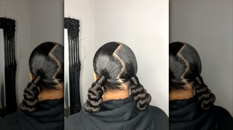 woman with slicked zigzag part pigtails