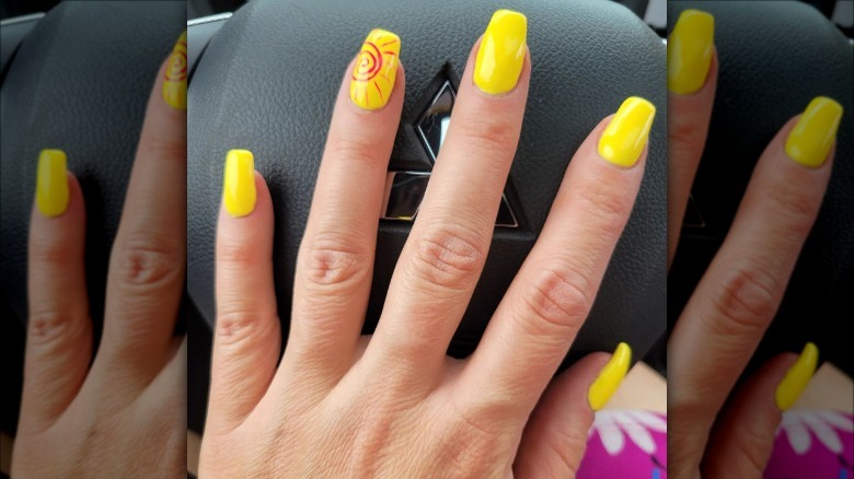 woman with bright yellow nails