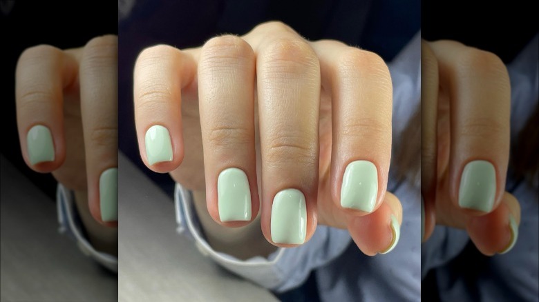 woman with mint green nails