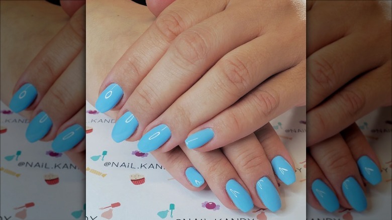 woman with sky blue nails