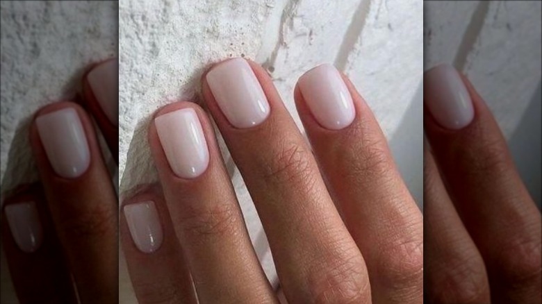 woman with milky white nails