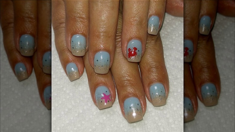 woman with blue crab nails