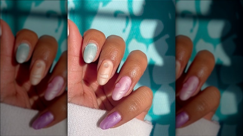 woman with pastel water drop nails