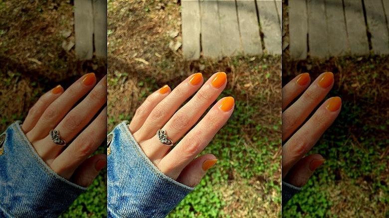 woman wearing orange nails