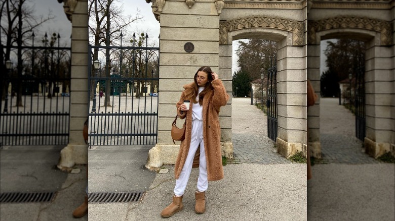 Woman wearing a teddy bear coat and Uggs