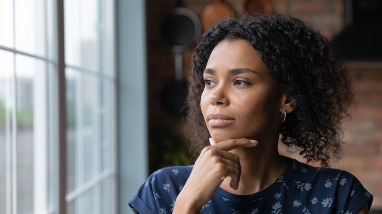 Woman daydreaming looking outside