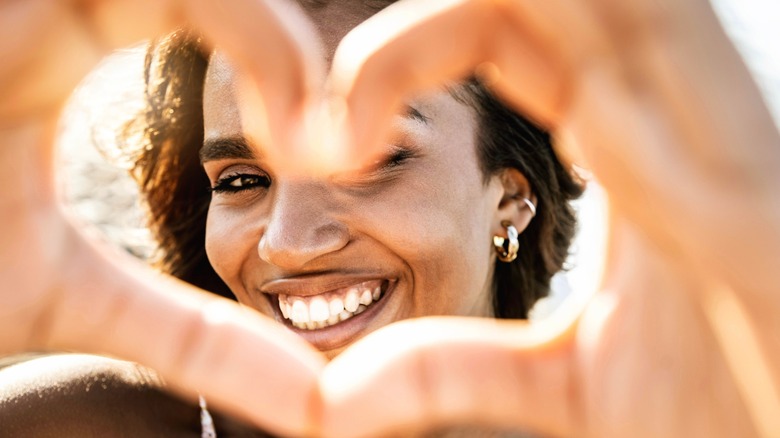 Woman making heart with fingers