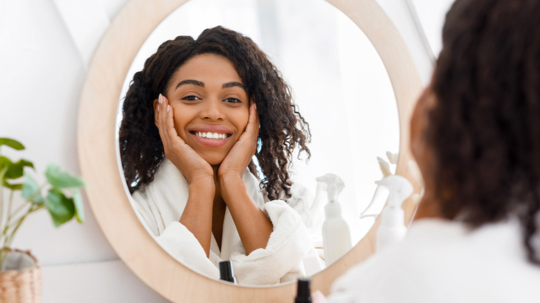 happy woman staring at reflection