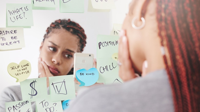 Sticky note affirmations on mirror 