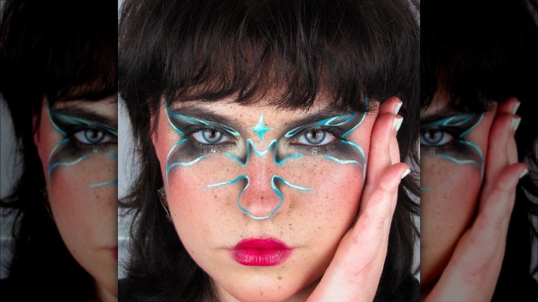 woman wearing blue black graphic eyeliner