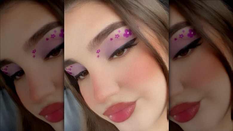 woman wearing flower graphic eyeliner 