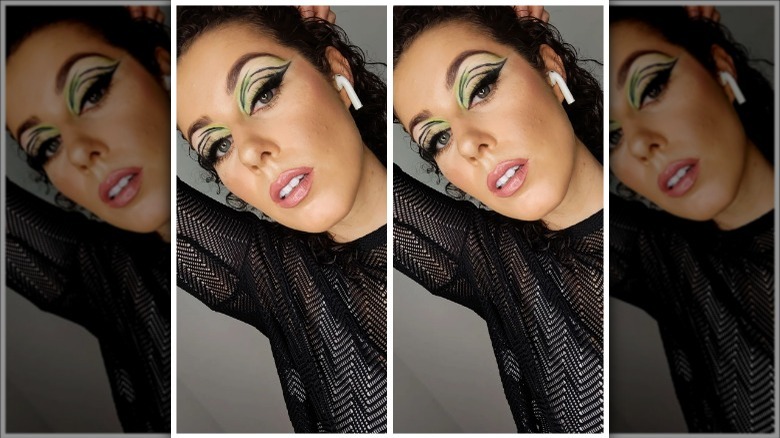 woman wearing green black graphic eyeliner