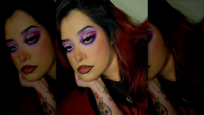 woman wearing glowing purple graphic eyeliner