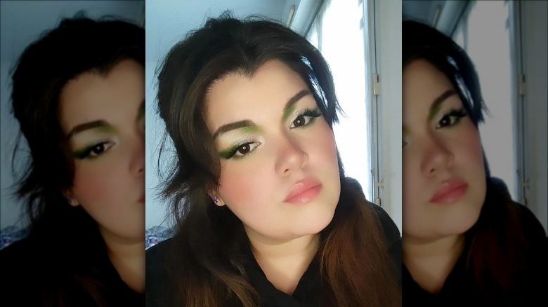 woman wearing green graphic eyeliner